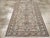 This mid-20th-century Persian Malayer rug presents a finely detailed floral composition across a muted grey-brown field....