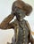 A finely detailed cold-painted bronze figure depicting a gentleman in period dress — tricorn hat, ruffled cravat, richly...