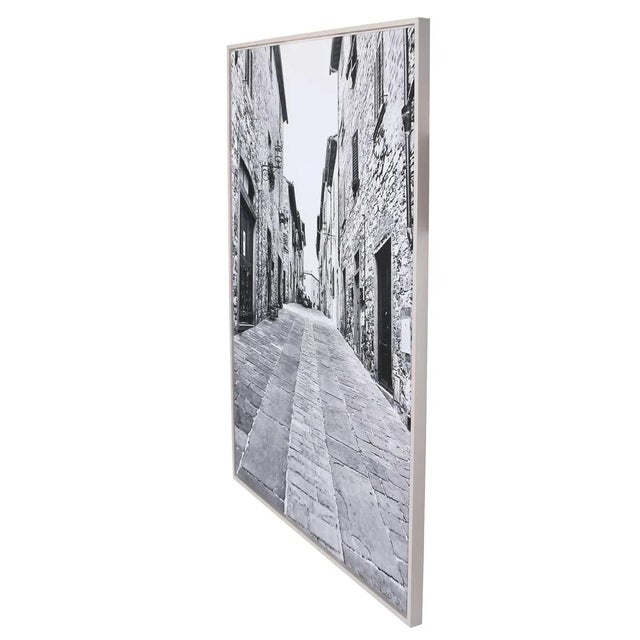 Impressionist black and white photograph of a walled Tuscan street, its softness and scale recalling the depth of a...