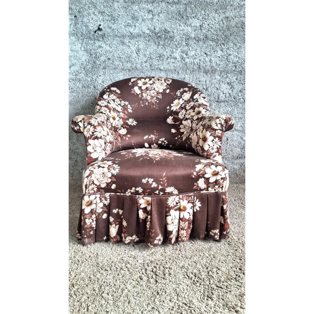 A napoleon iii style toadstool armchair with a characteristic silhouette: rounded, enveloping back, very low rolled...