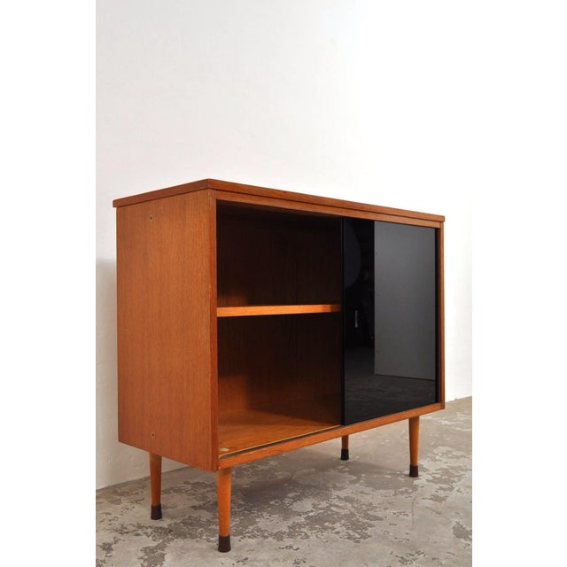 Produced by up závody in the 1960s. The cabinet features two glass doors in black smoked glass. This gives the cabinet a...