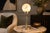 A striking vintage Art Deco / Machine Age table lamp featuring a frosted glass globe shade set above a streamlined metal...