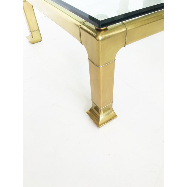 Incredible brass coffee table with Asian styling by Mastercraft. Composed of a brass frame and a glass top, this elegant...