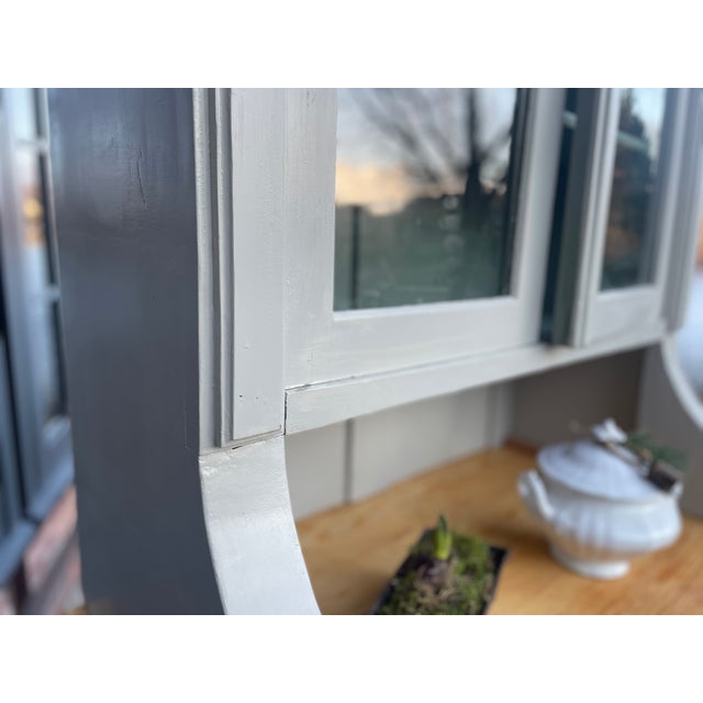 This charming antique kitchen sideboard consists of two parts: an upper and a lower section. We have repainted it, and...