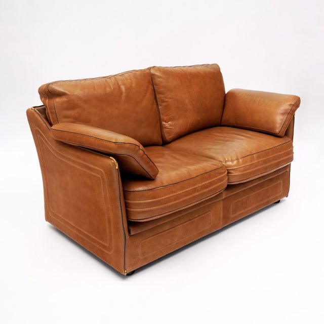 Sofa from mid-century France by renowned furniture brand Roche Bobois. This piece is made of camel colored leather with...