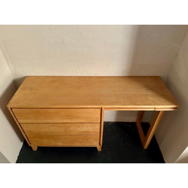 1950 Mid-century modern "Modernmates" writing desk in solid maple or birch featuring a three-drawer chest unit on the left...