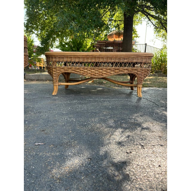 Pristine vintage wicker and rattan coffee table with glass top. This would be beautiful in a coastal home or sunroom. The...