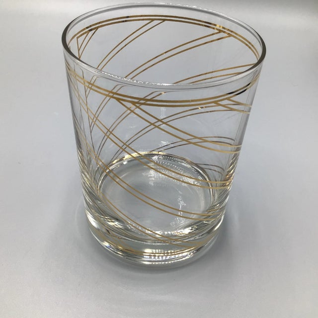 Here is a hard to find set of Four 22K gold double line spiral striped lowball/double old fashion glasses. This set of 4...
