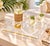 A vintage acrylic serving tray, decorated with a white and gold printed sun and palm trees design.