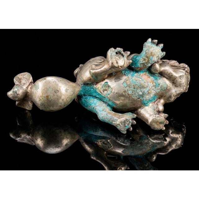 This sculpture is a finely cast Chinese Pixiu (or guardian lion), crafted from bronze with a luminous silver-plated finish...