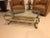 Mid-Century Modern brass and giltwood coffee table. Having Vintage brass legs with a bottom hand-carved and painted...