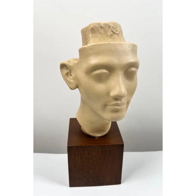 This refined reproduction bust, bearing the stamp “Musée du Louvre – Reproduction Interdite – Atelier de Moulage”,...