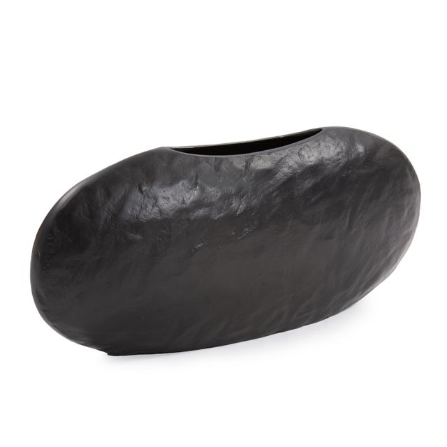 Hand cast aluminum on the simple linear design of this wide canoe vase takes on a whole new sophisticated feel in matte...