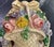 Charming early-20th-century cast iron door knocker in the form of a hand-painted floral basket. Rich with authentic patina...