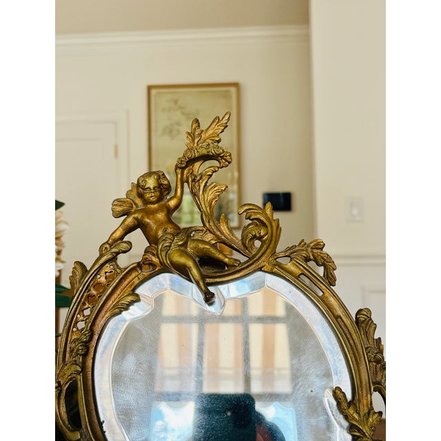A romantic table mirror in the Louis XV Rococo taste, cast in gilt bronze (or spelter) with exceptional sculptural detail....