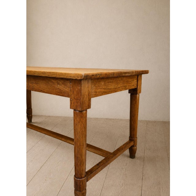 A beautiful, original antique solid wood table, characterized by generous proportions, traditional construction, and a...