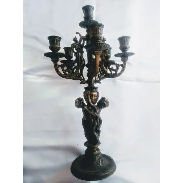 Antique French Neoclassical-Style six-Light Cherub Candelabras - a Pair. This ornate pair of antique French neoclassical-...