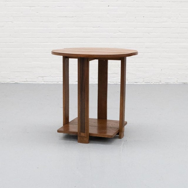 Dutch sidetable from the 1920s/30s, crafted from solid oak. The design features a clear, architectural construction with a...