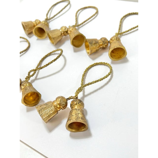 Vintage brass tassel napkin rings featuring metal braided cords and sculptural tassel accents with a warm, aged finish....