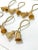 Vintage brass tassel napkin rings featuring metal braided cords and sculptural tassel accents with a warm, aged finish....