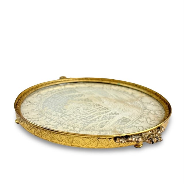 What a sweet little piece of history! This antique round vanity tray has the prettiest old lace tucked beneath glass, with...