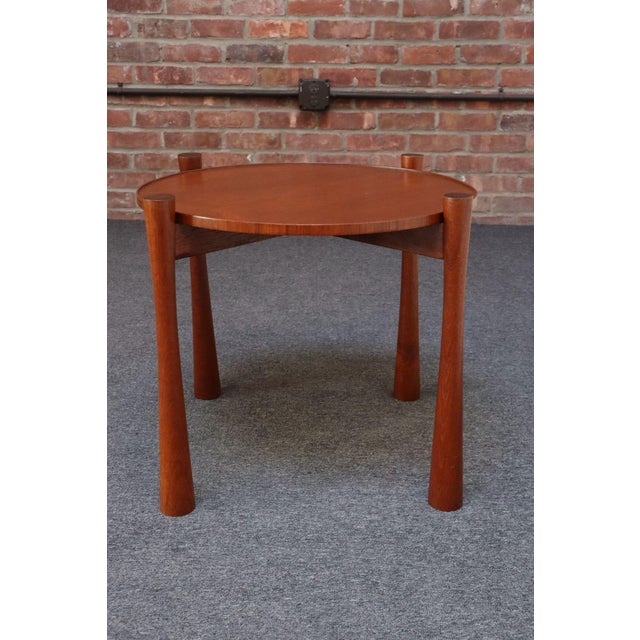 Vintage teak side/end table (ca. 1960s, Denmark). Composed of a teak base boasting deeply sculpted, dense legs supporting...