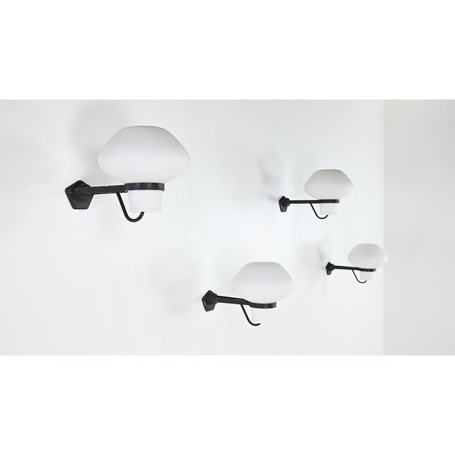 With its organically shaped blown glass shade, especially rare in this opaline frosted glass version, the ga9 resembles a...