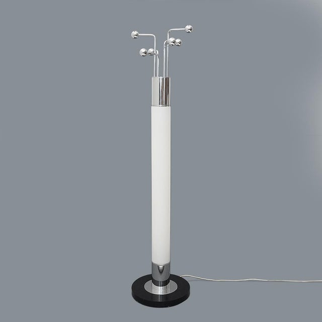 Italian-made floor lamp and coat rack produced in the 1970s. Black lacquered wooden base. Chromed metal stem and white...