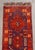 Persian Hamadan Runner, with geometric design on a red ground. 4' 9" L x 1' 3.5" W. Provenance: From a Connecticut Estate.