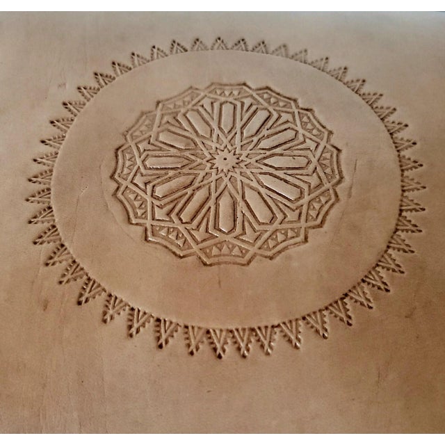 Handmade Moroccan camel saddle with genuine leather cushion and carved cedar wood base, measuring approximately 24 inches...