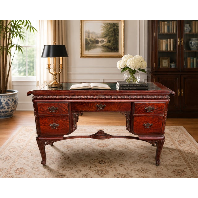This elegant antique Louis XV Revival desk features a richly finished wood frame with beautifully figured drawer fronts,...