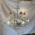 A stunning, highly decorative Venetian glass chandelier featuring hand-blown floral elements and elegantly curved glass...