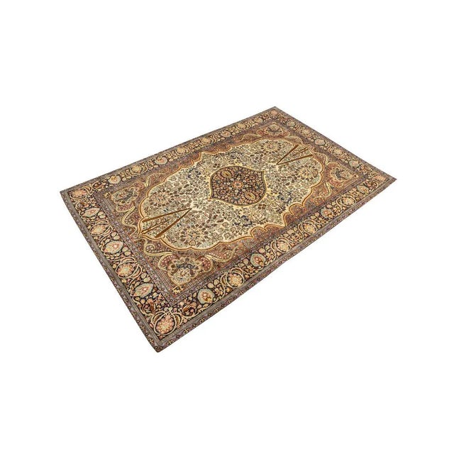 Rug from the 1960s from the holy city of Qum. Wonderful pile with a dark blue medallion on beige base with accents in...