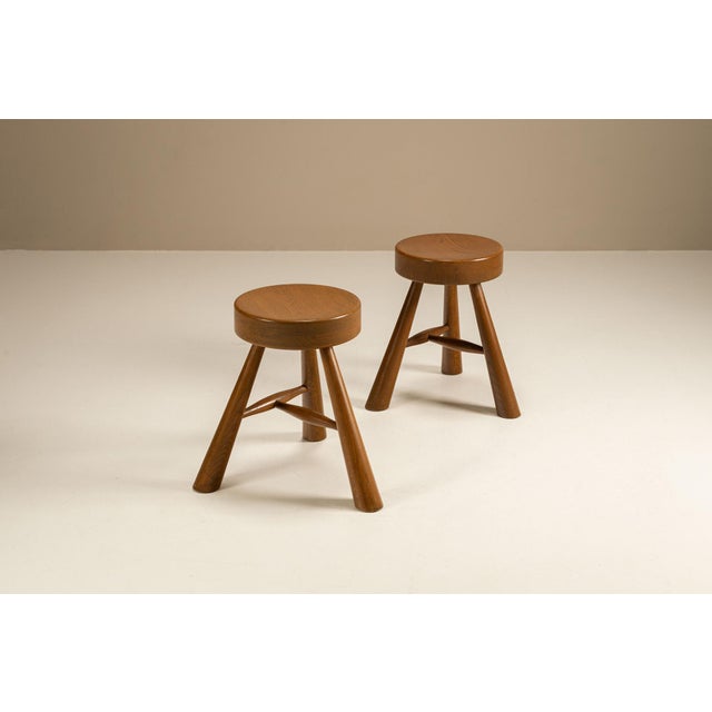 Balance and clarity characterise this refined pair of wooden stools, echoing the design language of Charlotte Perriand....