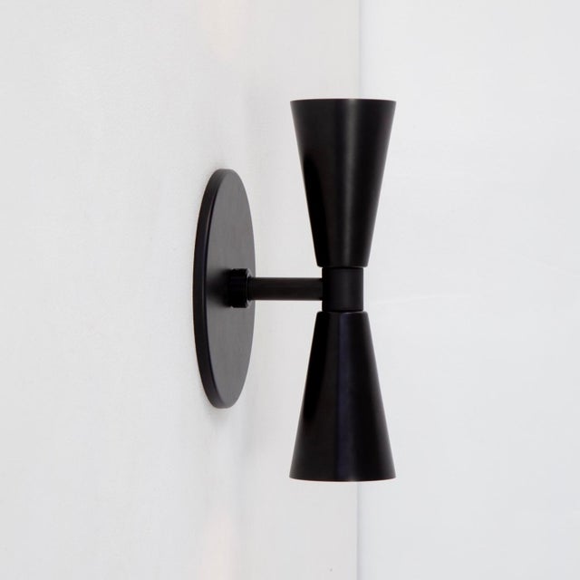 Up and down, the Small Cone 2 balances soft light with sculptural simplicity. Subtle, but never shy. Materials: Steel,...