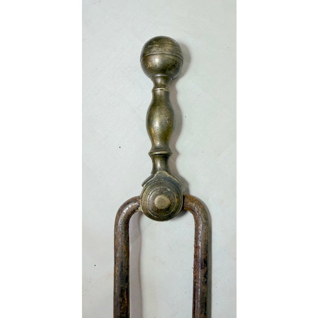 Up for sale is a pair of rare antique 18th century wrought iron and brass English fireplace tongs. The arms are wrought by...