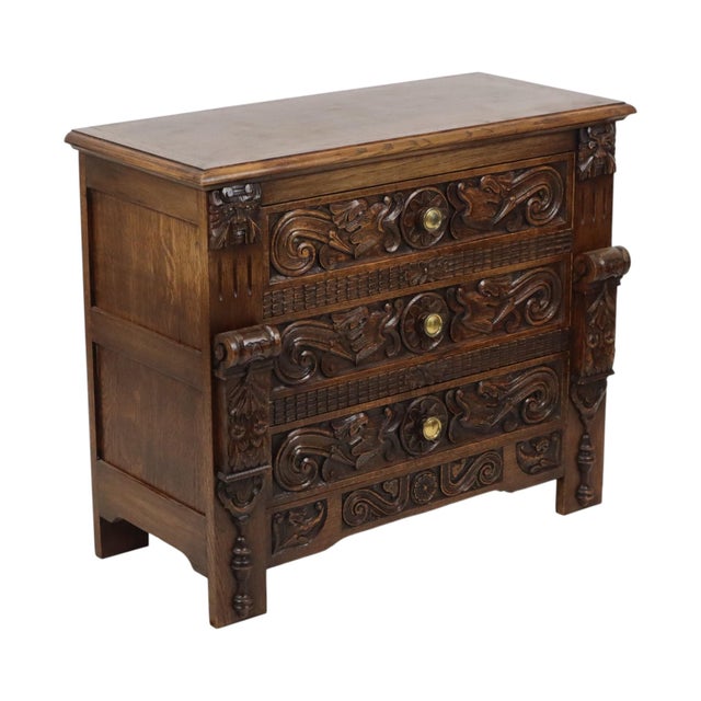 Vintage carved chest of drawers featuring three drawers; high-quality construction from solid stained oak. The front...