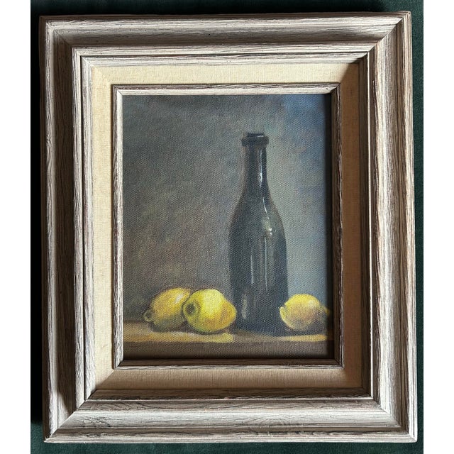 Vintage oil painting still life of lemons and bottles. In vintage wood frame. Painting measures 8” x 10”.