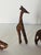 3 S Safari handcarved painted wooden figurines of a giraffe, a zebra and an elephant.