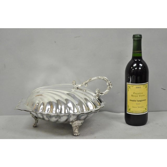 Vintage Regency Style Large Silver Plated Clam Shell Hinged Footed Warmer with Floral Handle. Circa Mid 20th Century....