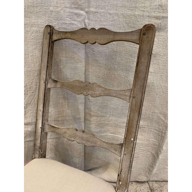 A charming C18th provincial french oak chair which has a tall ladder back, turned legs and curved stretcher. The low but...