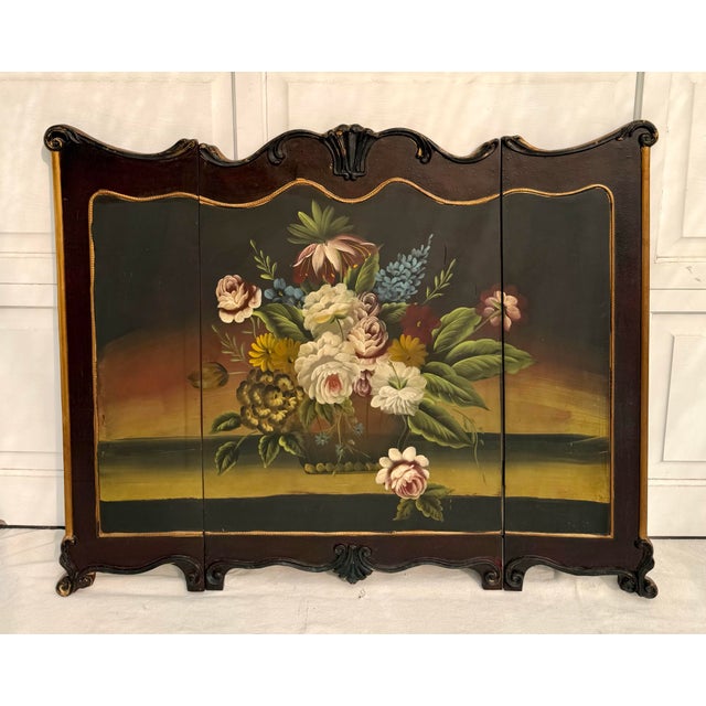 Here is a beautiful folding fireplace screen featuring a hand-painted floral still-life set within a Florentine-style...