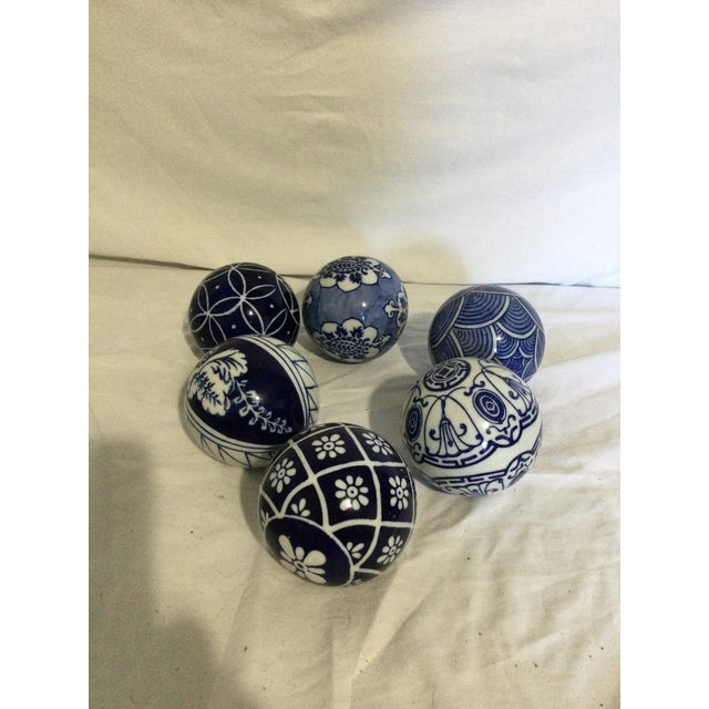 Painted with images of flower porcelain spheres transform Ming tradition into modern focal points. Arrange them in a bowl,...