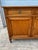 A walnut Louis XVI three-door buffet, French, 19th century, featuring elegant neoclassical lines, paneled doors, and...