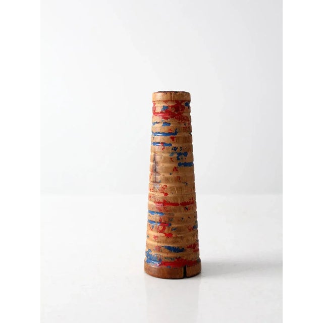 Beautifully aged, with great character, this is a vintage wooden children's toy circa 1930. The wooden spool cone shaped...