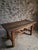 Antique oak dining table from France, dating from approximately 1750–1850. The table has a beautifully aged top made from...