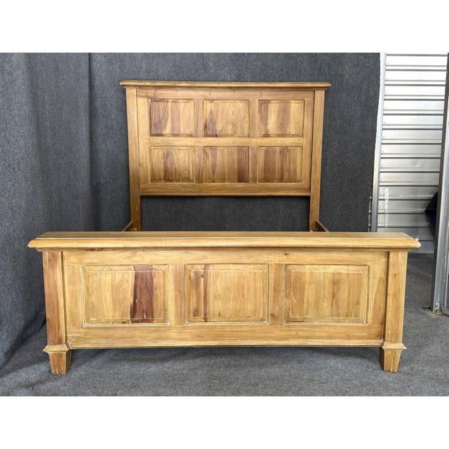 This Steven Shell Homestead king size bed frame features a warm, natural wood finish with clean paneled detailing that...