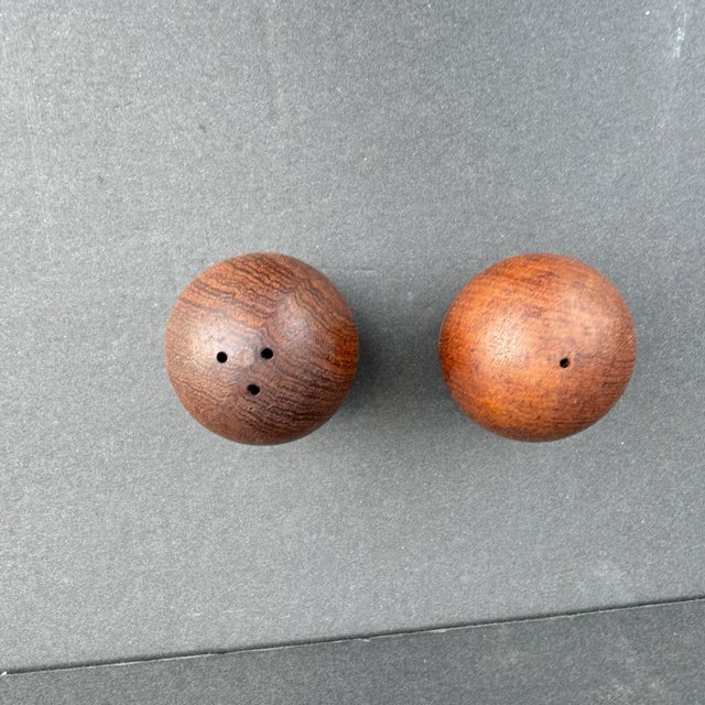 Pair of vintage salt and pepper shakers made from wood and in universal style, which compliments many different place...