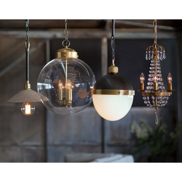 Circular glass globe pairs with three candle styled cluster to lend sculptural, contemporary style. Its clean lines and...