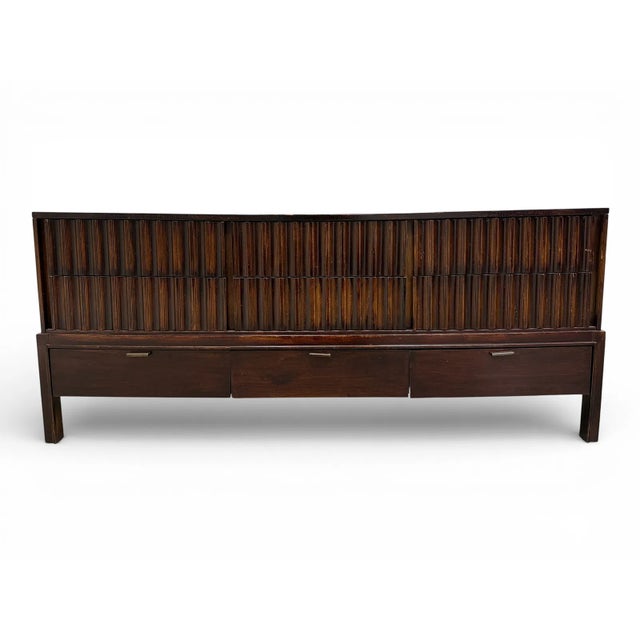 Mid-century modern nine-drawer dresser, circa 1960s, with a distinctive architectural design and deeply fluted drawer...